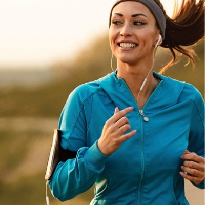 Happy woman jogging with headphones